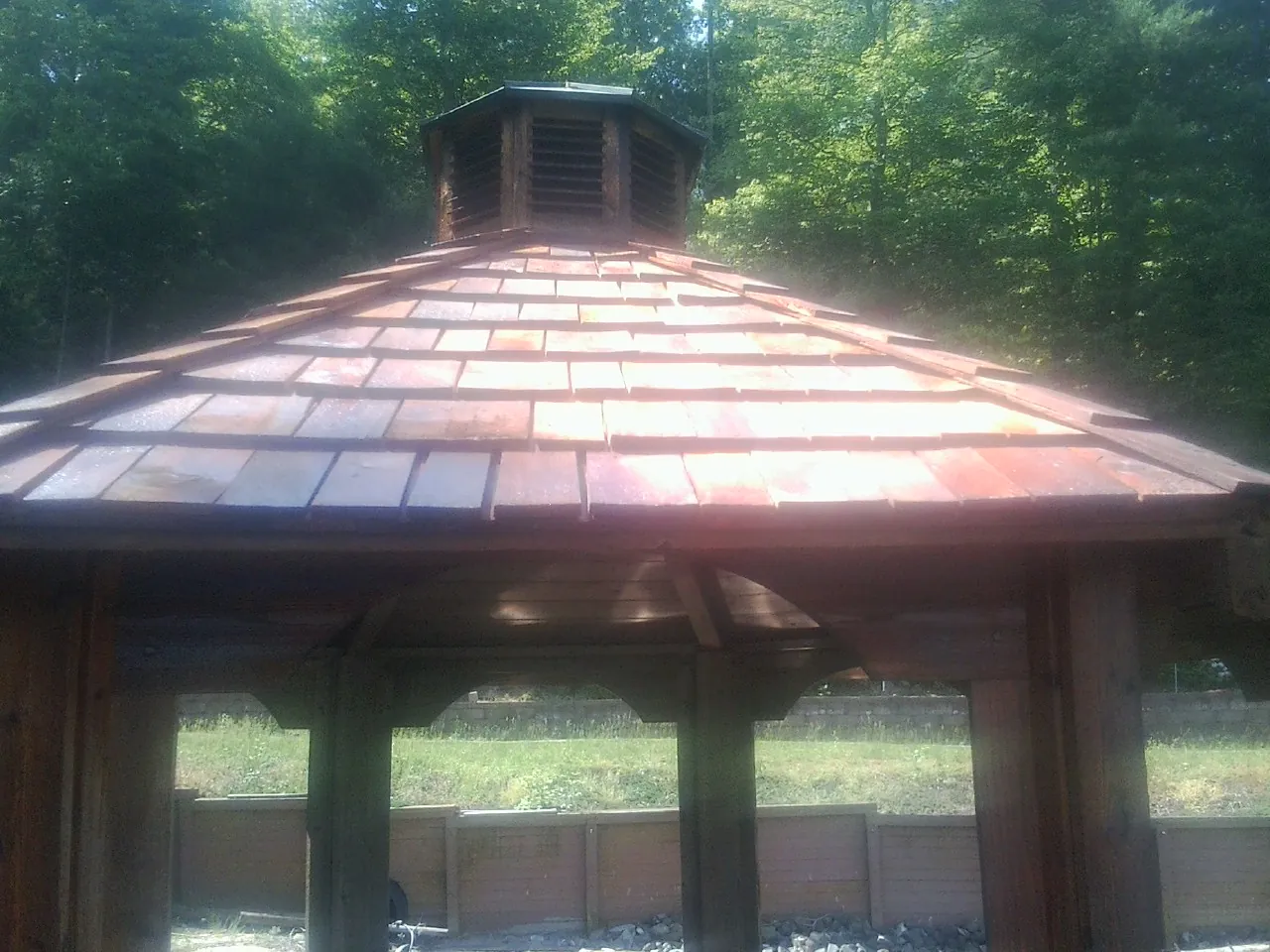 New cedar shake roof and cupola on a lakeside gazebo in Waveland